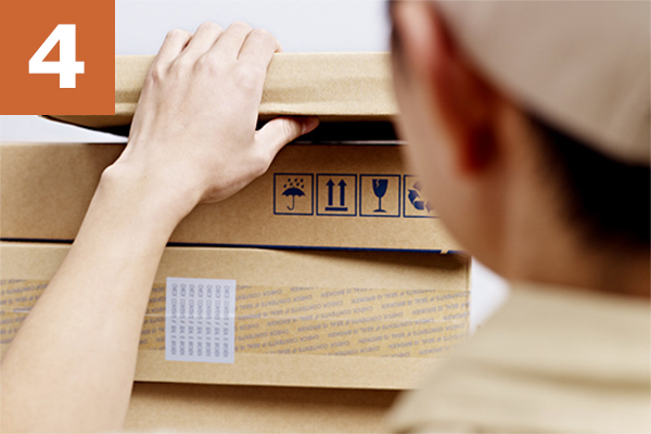 Person placing packages on top of each other to signify the deployment of a website developed by Adirondack Website Design.